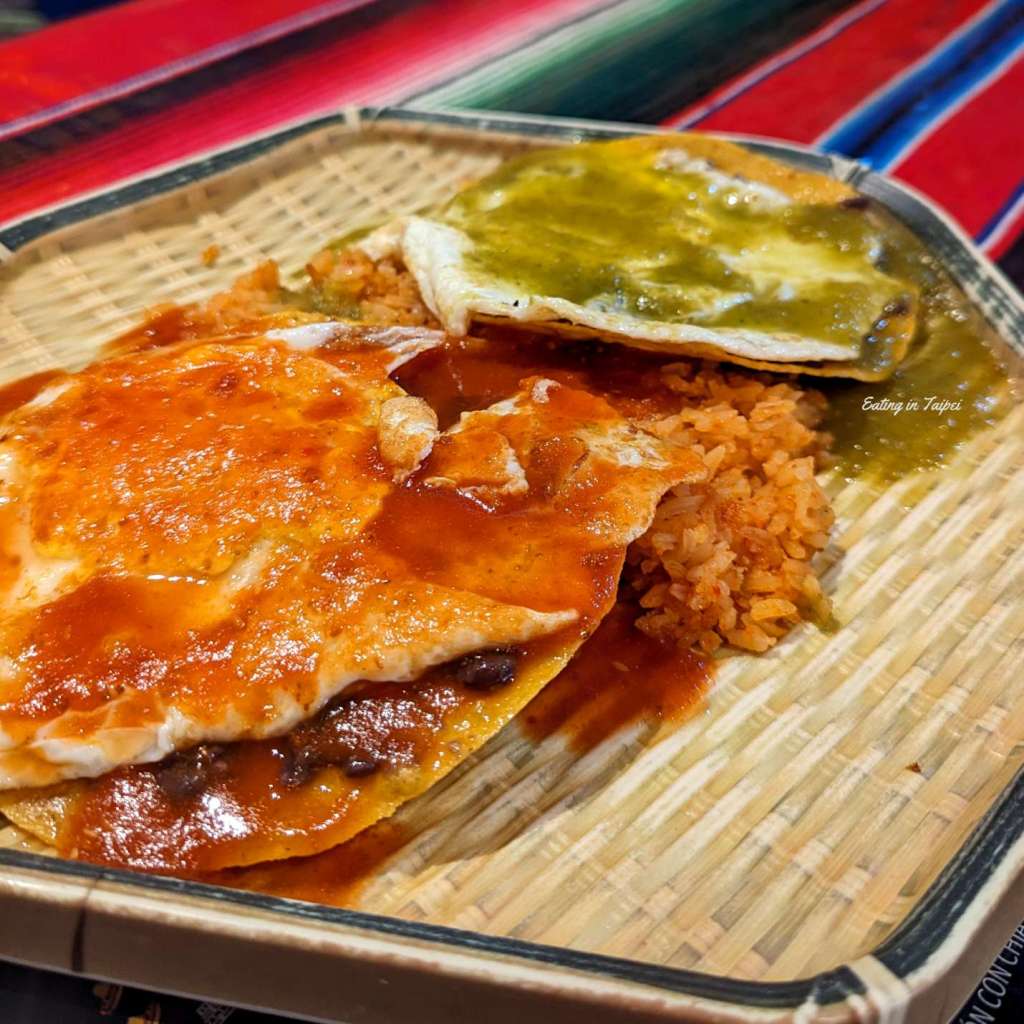 Fonda Mexico tortilla chips simmered in green and red sauce with eggs